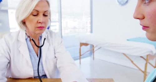 Doctor Examining Patient in Bright Office