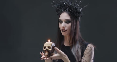 Woman Holding Skull Candle with Goth Aesthetic