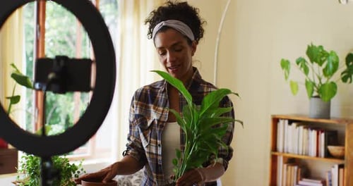 Woman Filming Video About Plants in Her Home