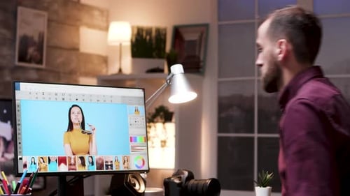 Young Photographer Sitting Down on Office and Working on Photos