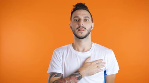 Man Pledging Allegiance, Hand Over Heart on Orange