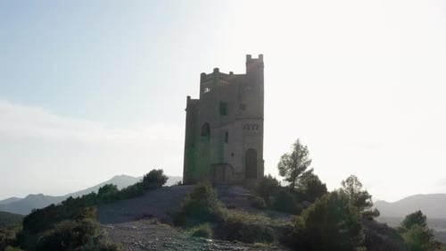 Drone Shot of Sunlight Beaming on a Castle on Top Of a Hill in Spain