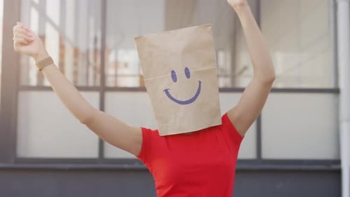 Person Dances with Paper Bag with Smiley Face