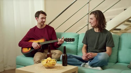 Two Young Men Enjoying Music at Home
