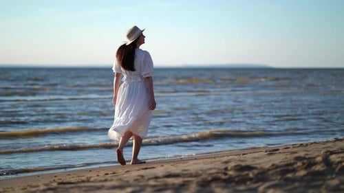 Pretty Woman Walks at Seaside Surf