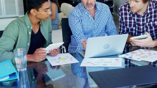 Businessmen Work Together at Table in Modern Office
