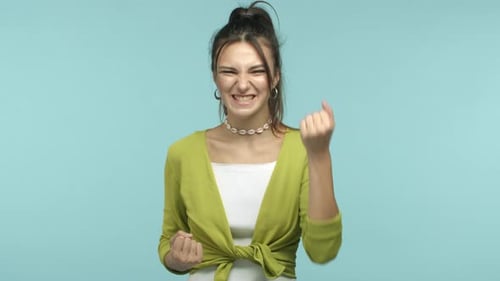 Slow Motion of Young Attractive Woman Feeling Like Champion Winning Prize and Rejoicing Making Fist