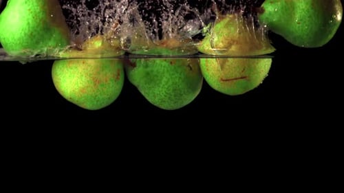 Pears Splash in Water on Black Background