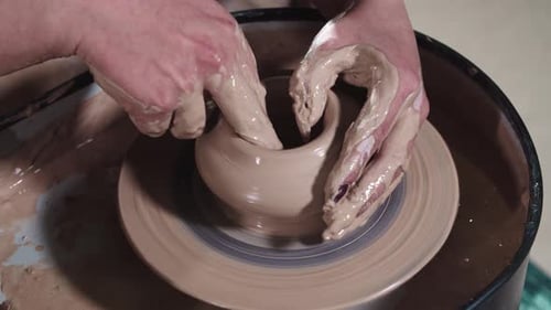Hands Shaping Clay on Potter's Wheel