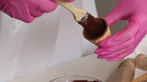 Waffle Cone Being Painted with Melted Chocolate