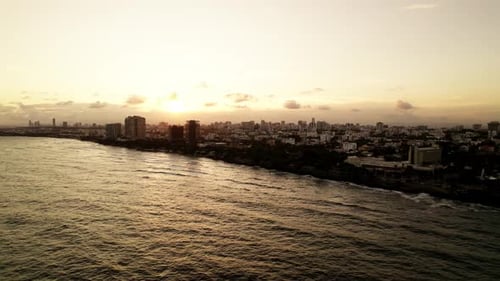 Aerial. Drone view on the sunset Santo Domingo city silhouette at the city and epic sun.