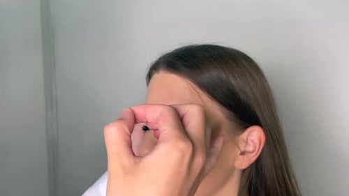 Woman Getting Eyebrows Threaded at Salon