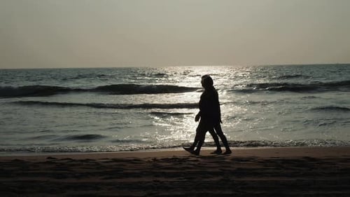 Couple Pair Old Adult on the Beach Silhoueete with Sunset Sky