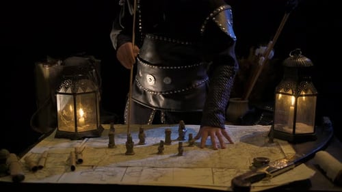 Strategist planning with map and arrow in candlelight