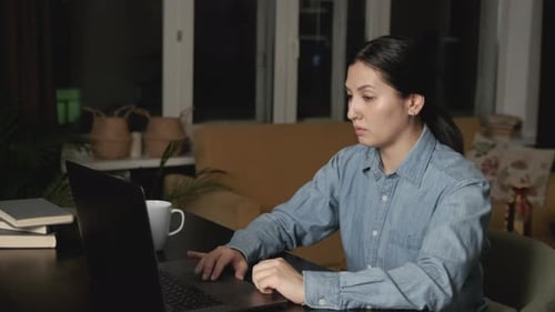 Woman Works At Laptop Computer in Dark Room
