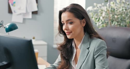 Young Woman Working at Computer in Office Setting