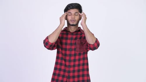 Young Adult Massaging Temples for Headache Relief