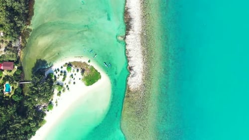 Beautiful shore of tropical island with white sandy beach and coral reef barrier washed by turquoise