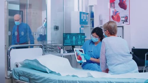 Doctor Explains Heart to Senior Patient in Hospital