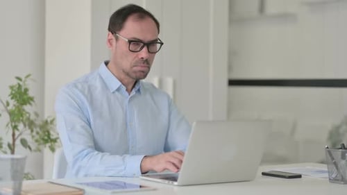 Man Working at Desk in Home Office