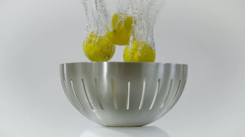 Lemons Falling into Bowl of Water