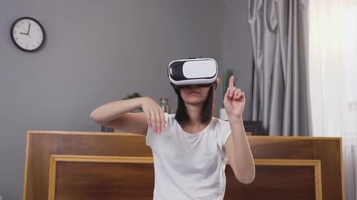 Woman Using VR Headset in Bedroom
