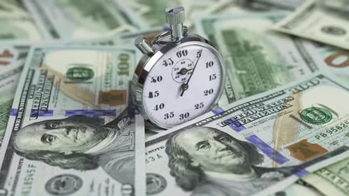 Stopwatch on Pile of One Hundred Dollar Bills