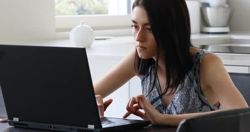 Woman Working on Laptop Computer at Home