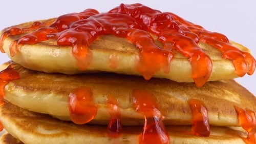 Pancakes Doused with Bright Red Strawberry Jam