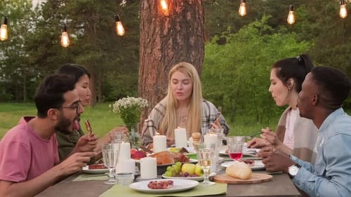 Friends Gather for Outdoor Meal in Natural Setting