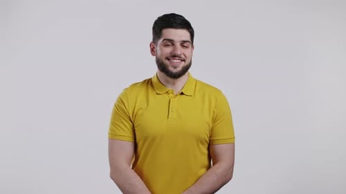Smiling Man Puts Hands on Waist in Studio