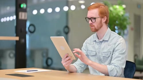 Excited Casual Redhead Man Celebrating Success on Tablet