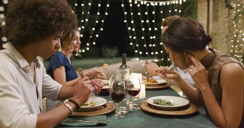 Friends Sharing Dinner Together at Night