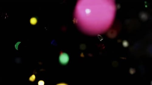 Colorful Confetti Glitter Falling on Black Background