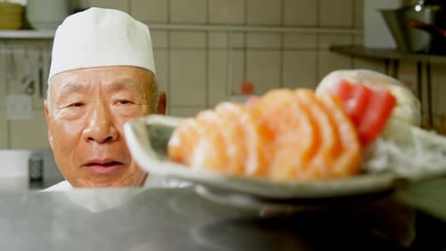 Chef Presents Plate of Delicious Salmon Sashimi