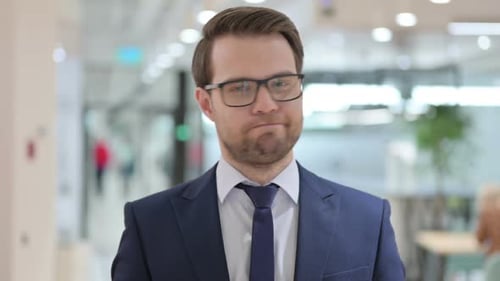 Business Man Looking at Camera in Office