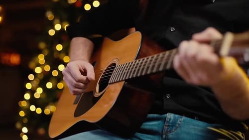 Man Plays Guitar Close-up. Shooting in Slow Motion.