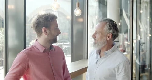 Two business partners having an informal meeting at a cafe