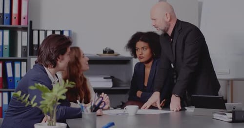 Colleagues Collaborating at Office Meeting