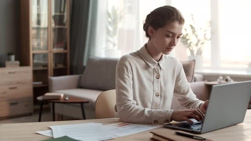 Woman Working at Laptop from Home