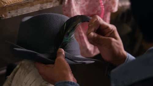 Mixed race woman working at a hat factory