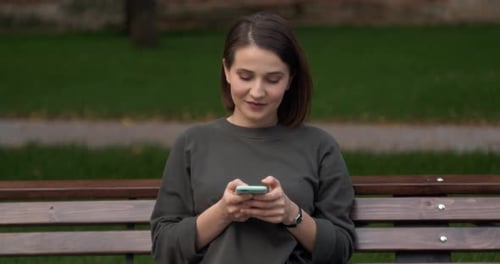 Happy Girl Using a Smart Phone Voice Recognition Audio Message Function on Line Walking on a Street