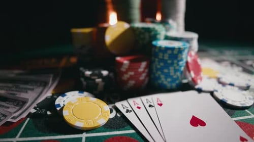 Casino Chips with Dice and Playing Cards on a Dark Table