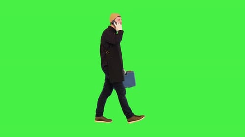 Man Walks and Talks on Phone on Green Screen