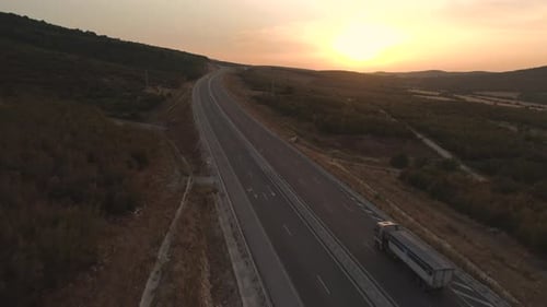 Blue Truck with Trailer on Countryside Road in Motion with Fields