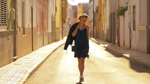 Trendy Woman Taking a Quick Afternoon Stroll in a Quiet Street