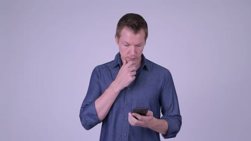 Young Adult Using Mobile Phone, Thinking in Studio