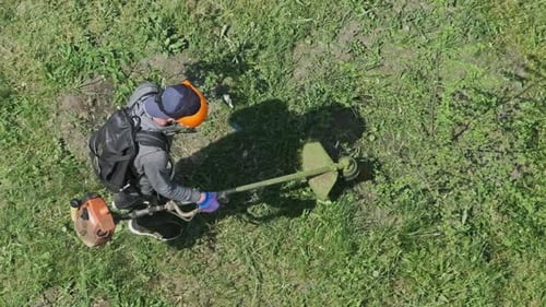 Man Mows the Grass with a Manual Petrol Lawn Mower in Slow Motion