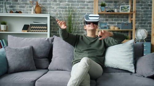 Young Man Using VR Headset at Home
