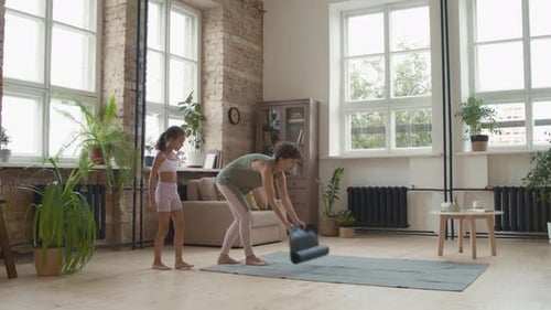 Mother and Daughter Doing Yoga at Home